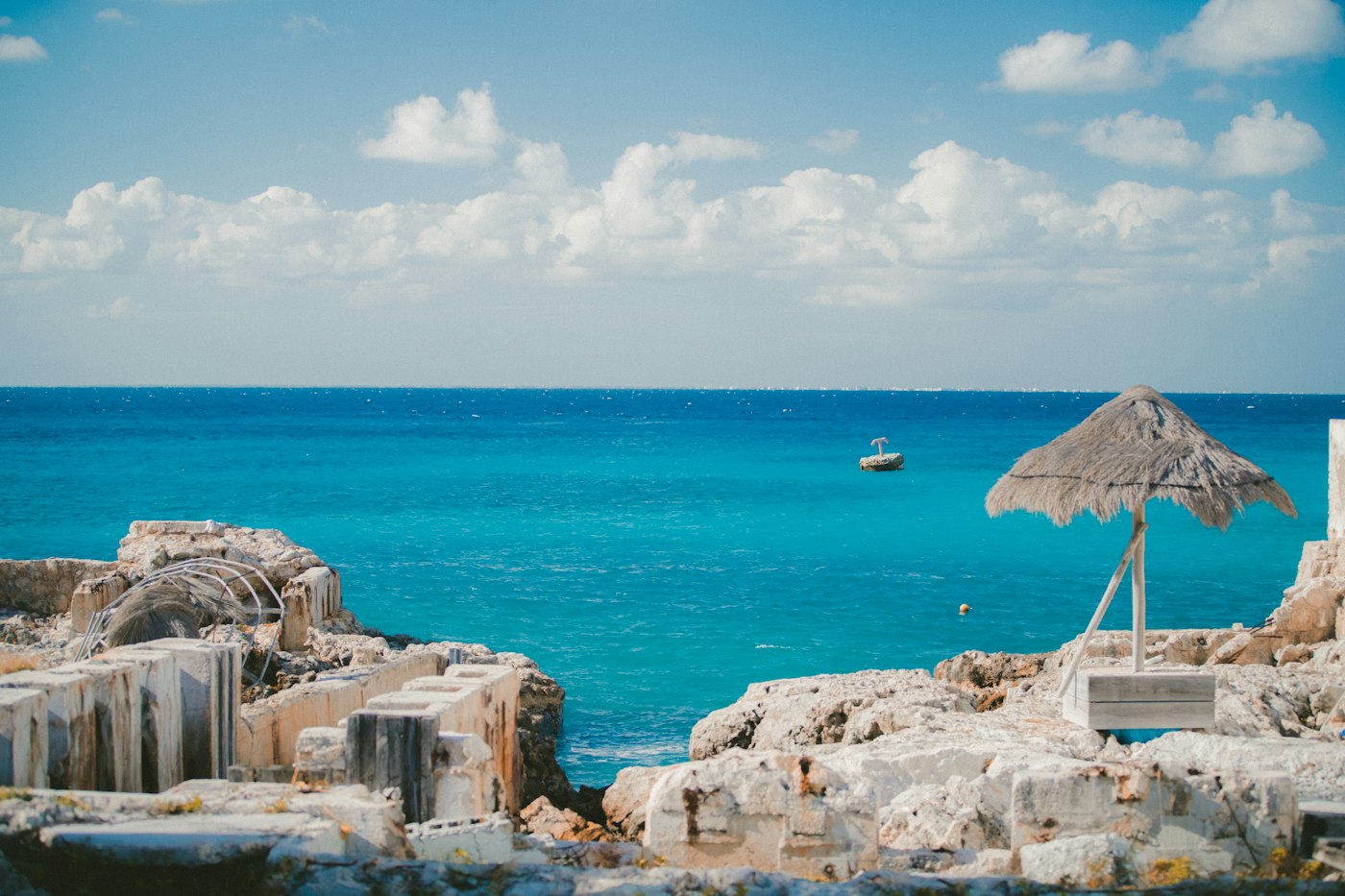 Turquoise sea and palapa in Cozumel, Mexico